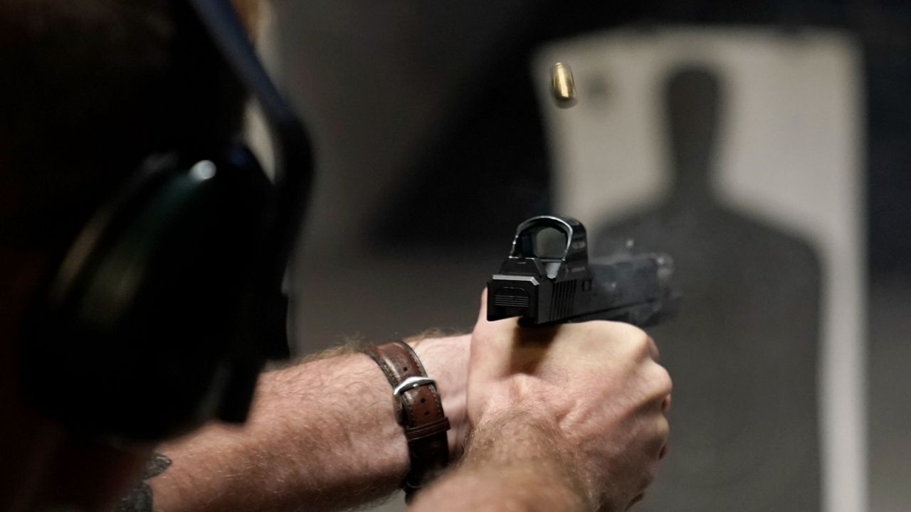 A man fires his pistol at an indoor shooting range in Roseville, Calif., on July 1. (AP Photo/Bebeto Matthews, File)