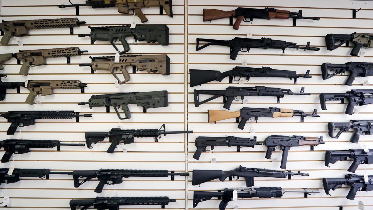 In this Oct. 2, 2018, file photo, semi-automatic rifles fill a wall at a gun shop in Lynnwood, Wash.