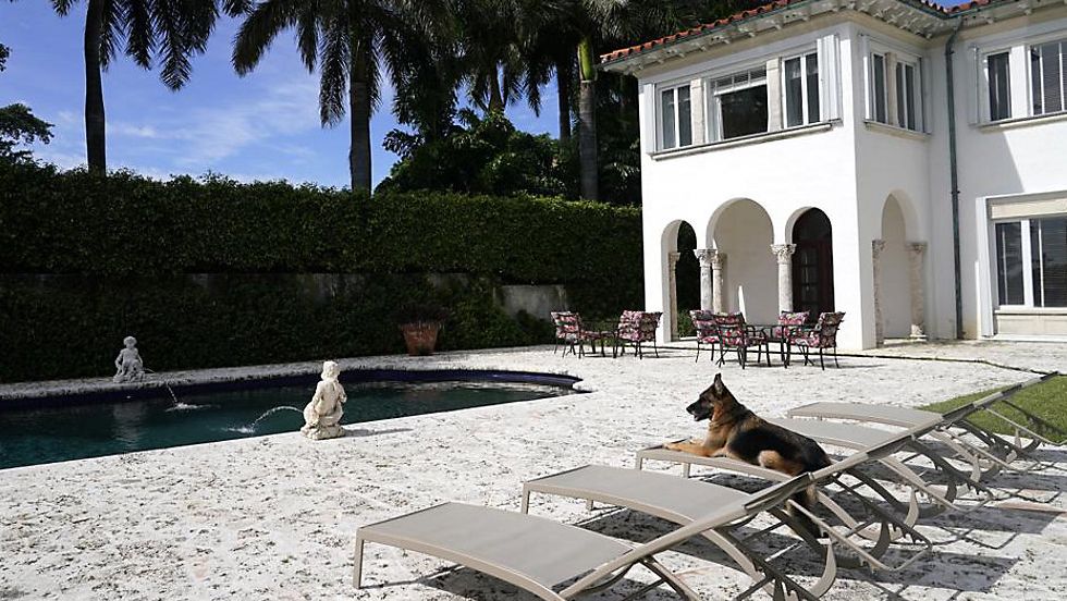 German shepherd Gunther VI sits by the pool at a house formally owned by pop star Madonna on Nov. 15 in Miami. (AP Photo/Lynne Sladky)