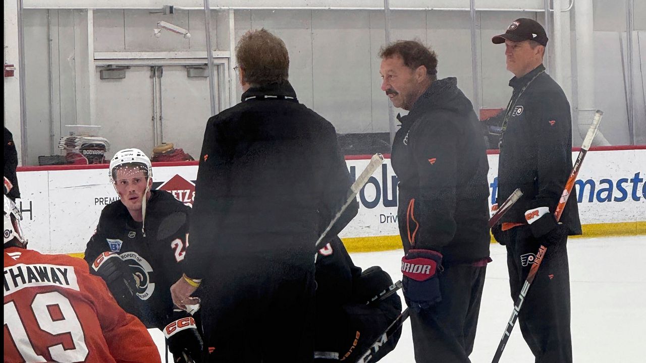 The Philadelphia Flyers host Guy Gaudreau, second from right, the father of Johnny and Matthew Gaudreau, at the team's morning skate, Monday, Sept. 23, 2024, in Voorhees, N.J. (The Philadelphia Inquirer via AP)