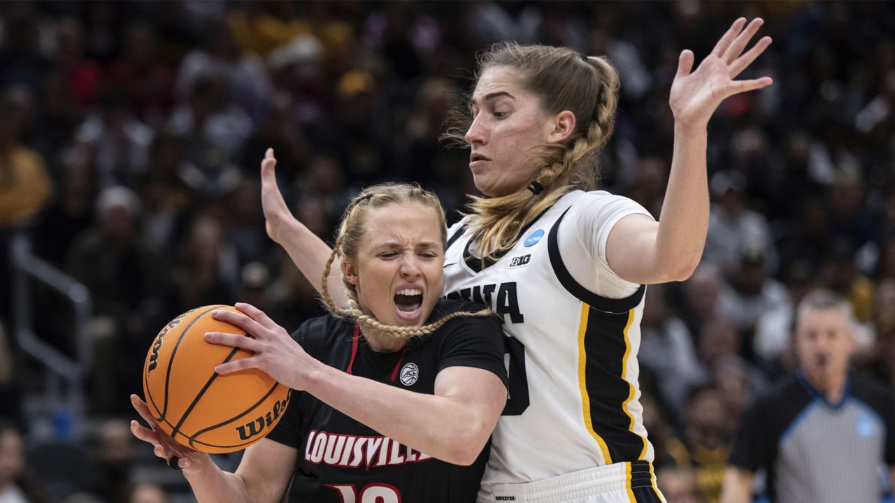 Former Louisville guard Hailey Van Lith (10) drives past Iowa guard Kate Martin during the first half of an Elite 8 college basketball game of the NCAA Tournament, Sunday, March 26, 2023, in Seattle. (AP Photo/Stephen Brashear)