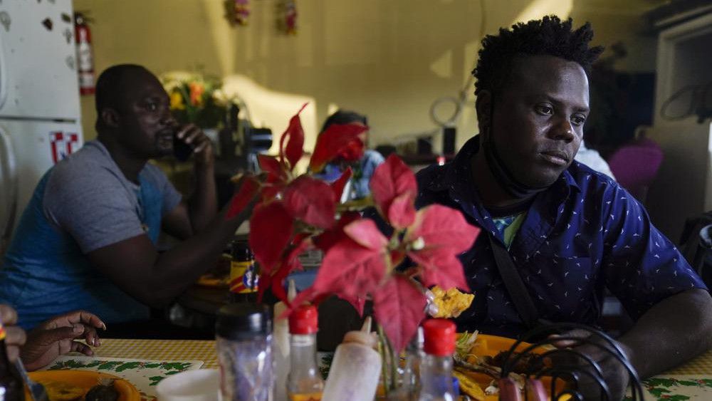 Robins Exile, of Haiti, eats at a Haitian restaurant, Monday, Sept. 20, 2021, in Tijuana, Mexico. (AP Photo/Gregory Bull)
