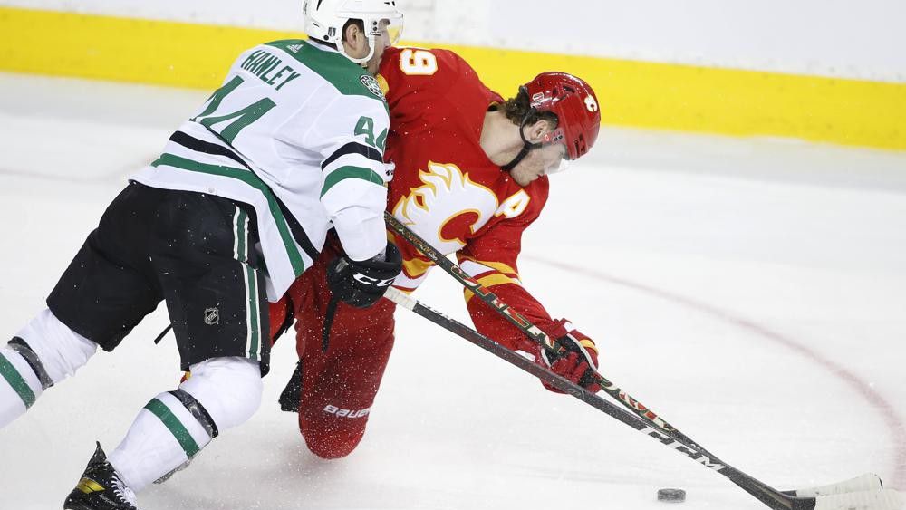 Dallas Stars defenseman Joel Hanley (44) checks Calgary Flames left wing Matthew Tkachuk (19) during the third period in Game 5 of an NHL hockey Stanley Cup first-round playoff series, Wednesday, May 11, 2022 in Calgary, Alberta. (Larry MacDougal/The Canadian Press via AP)