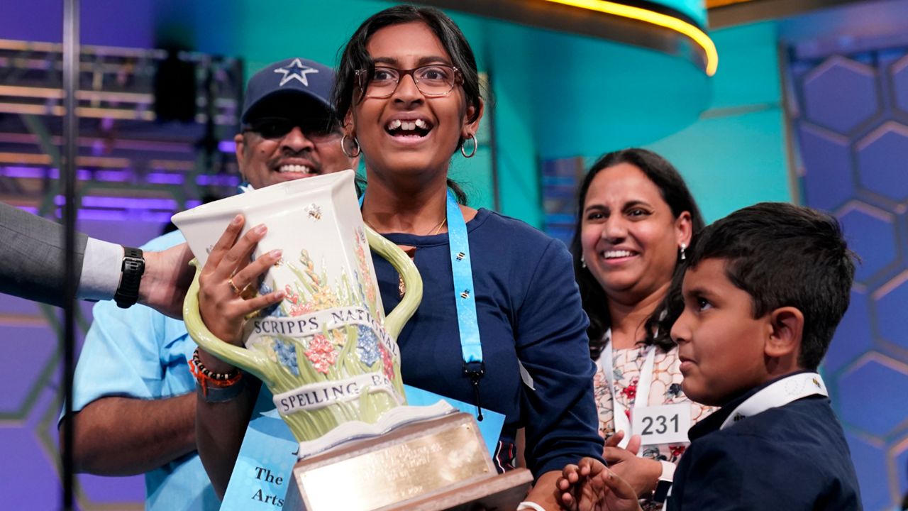 Harini Logan, 14, from San Antonio, Texas, celebrates winning the Scripps National Spelling Bee with her family, brother Naren Logan, right, mom Rampriya Logan, second from right, and dad Logan Anjaneyulu, left, Thursday, June 2, 2022, in Oxon Hill, Md. (AP Photo/Alex Brandon)