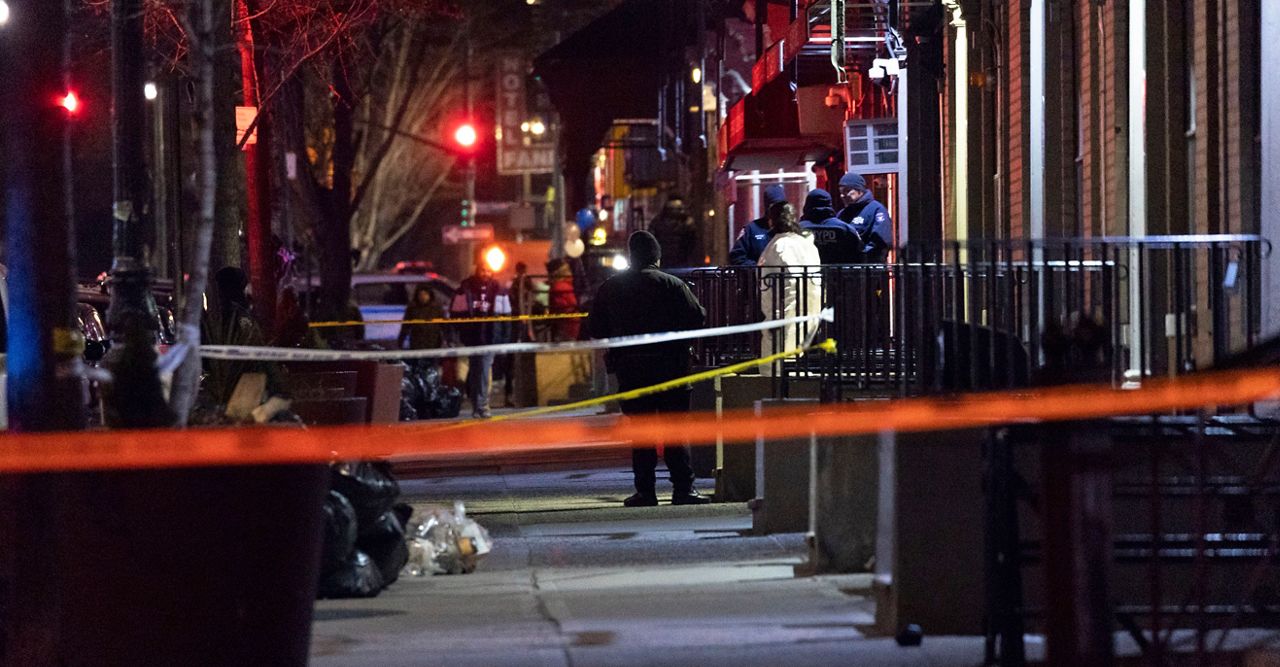 Crime scene investigators examine the scene of a shooting in Harlem on Friday, Jan. 21, 2022, in New York. 