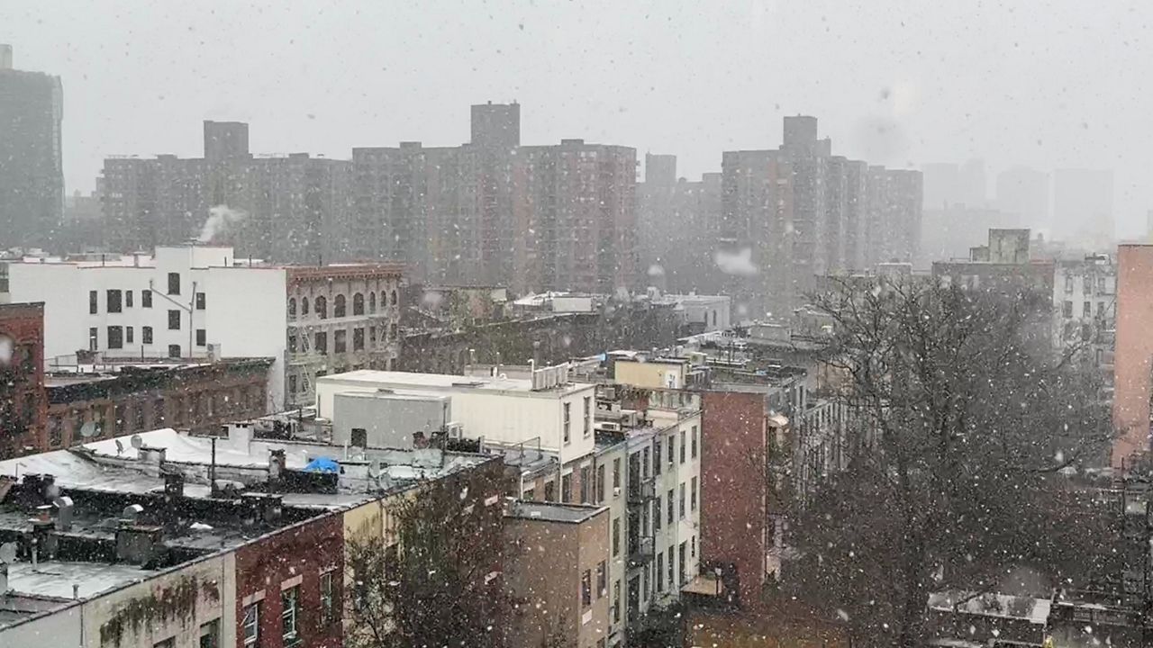 Snow is pictured falling in Harlem.