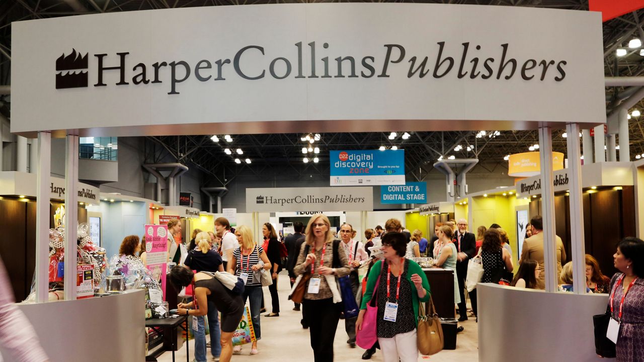 Attendees at BookExpo America visit the HarperCollins Publishers booth in New York on May 28, 2015.
