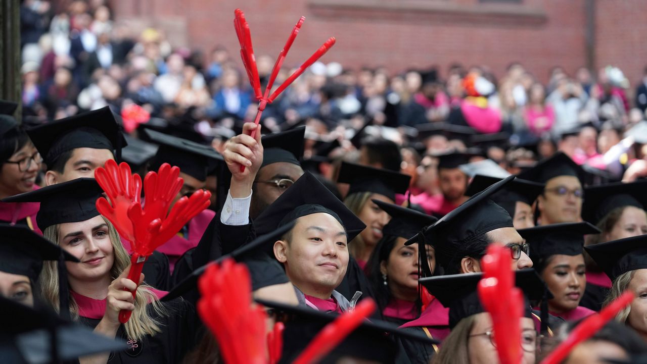 Harvard University students celebrate their graduate degrees in public health during Harvard commencement ceremonies on May 25 in Cambridge, Mass. (AP Photo/Steven Senne, File)