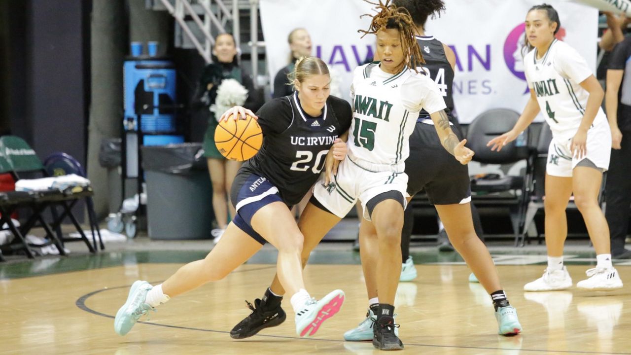 UC Irvine's Hunter Hernandez went around a screen against Hawaii forward Daejah Phillips in the second half of the Anteaters' overtime road victory over the Rainbow Wahine. 