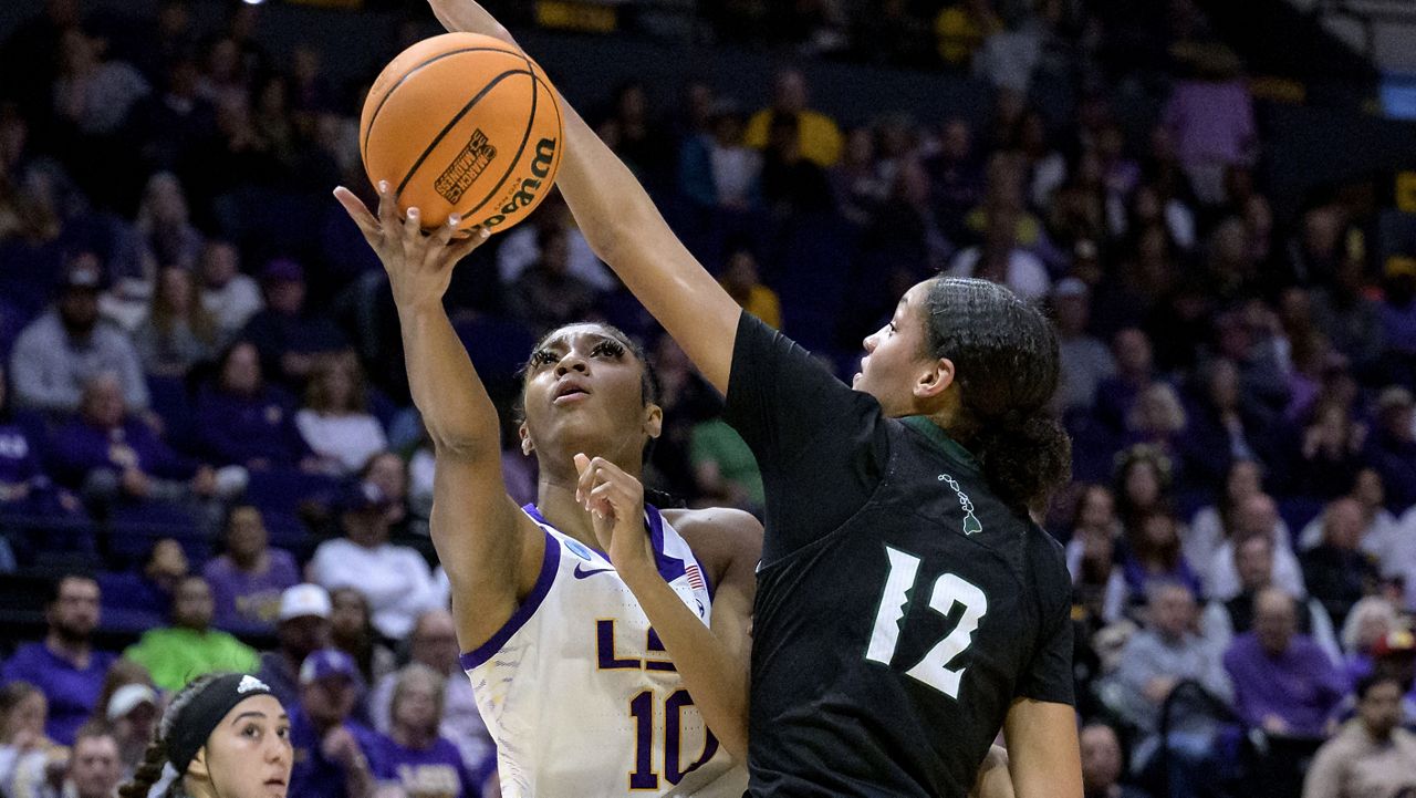 LSU forward Angel Reese shot underneath the outstretched arm of Hawaii center Imani Perez in the first half of an NCAA Tournament first-round game in Baton Rouge, La., on Friday.