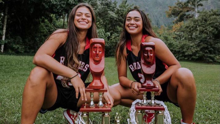 Sisters Lily Lefotu Wahinekapu, left, and Jovi Wahinekapu Lefotu, right, posed with Iolani's girls basketball state championship trophies from 2019 and 2020 at Hoomaluhia Botanical Garden in Kaneohe in 2020.