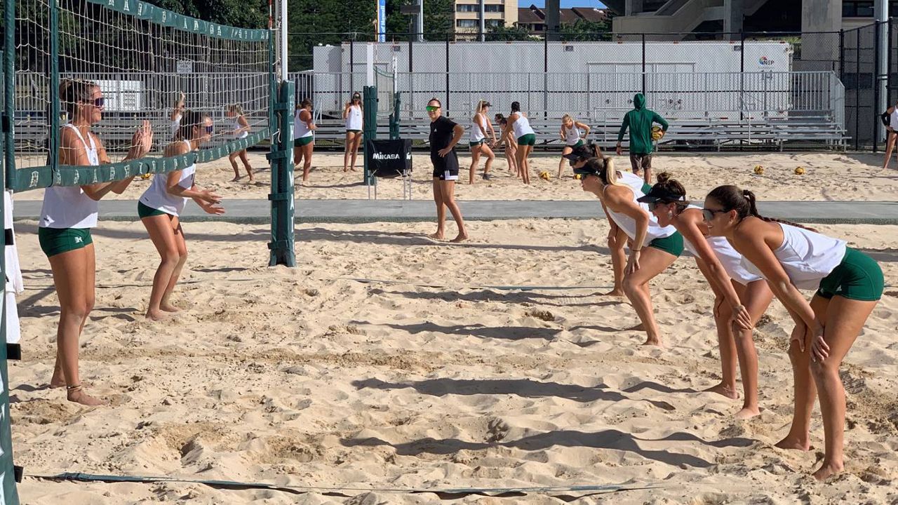 Hawaii beach volleyball players practiced at the Clarence T.C. Ching Athletics Complex sand courts in preparation for the 2022 season-opening tournament at Queen's Beach this weekend. Volunteer assistant coach Ginger Long, wearing black, looked over the players.