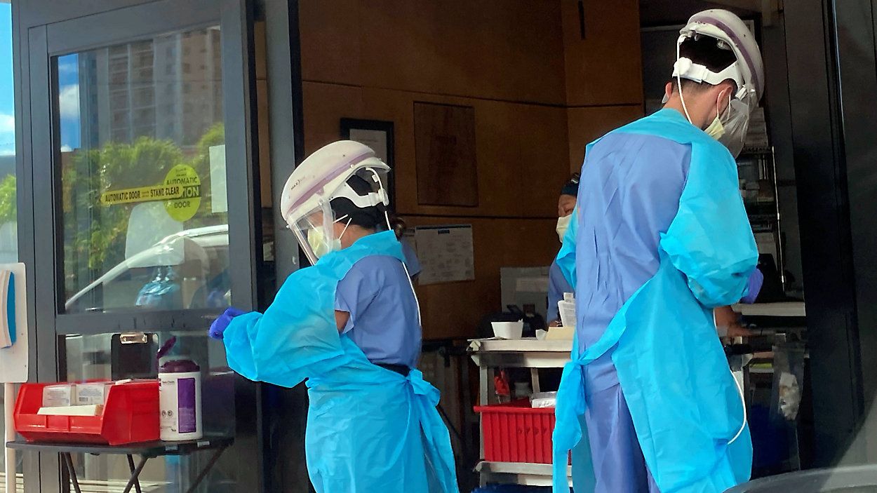 Hospital workers process COVID-19 tests at a hospital in Aiea, Hawaii. (AP Photo/Caleb Jones)