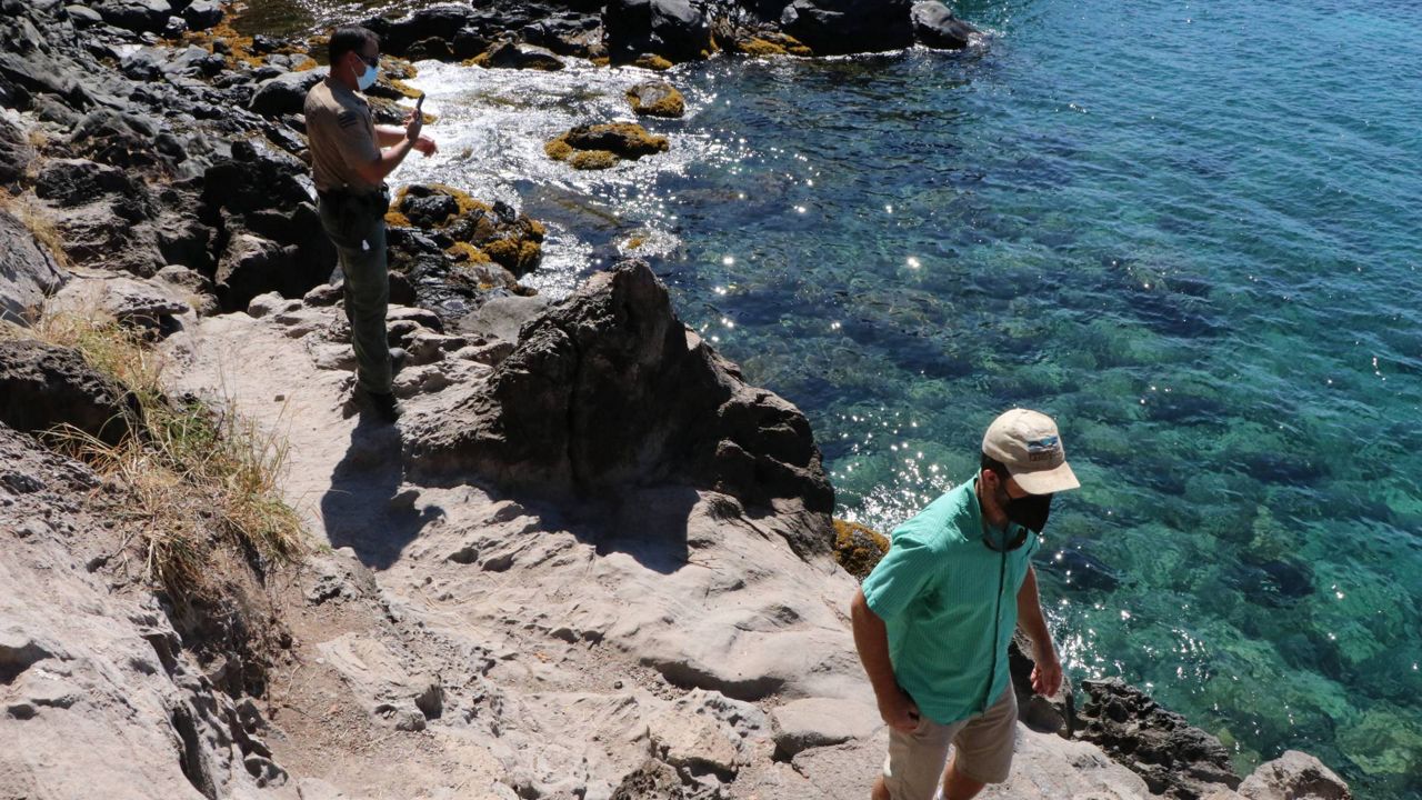 DOCARE officers and representatives from Hawaii Land Trust survey the area of public access at Hawea Point (Courtesy DLNR)
