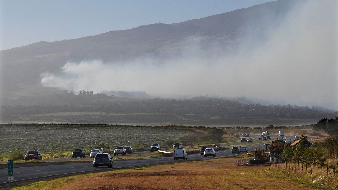 Smoke blows across the slope of Haleakala volcano on Maui, Hawaii, as a fire burns in Maui's upcountry region on Tuesday, Aug. 8. 2023. Several Hawaii communities were forced to evacuate from wildfires that destroyed at least two homes as of Tuesday as a dry season mixed with strong wind gusts made for dangerous fire conditions. (Matthew Thayer/The Maui News via AP)