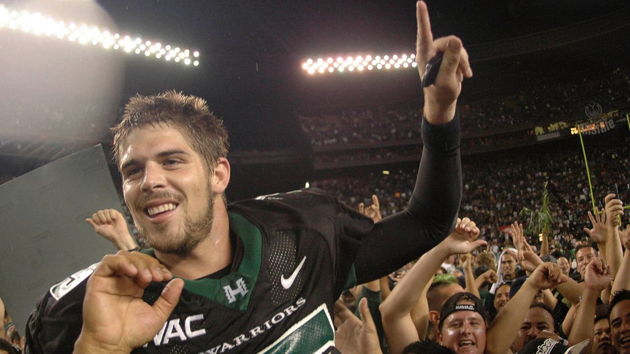 Former Hawaii football quarterback Colt Brennan celebrated with fans on the Aloha Stadium field after beating Boise State 39-27 for the WAC championship on Nov. 23, 2007. 