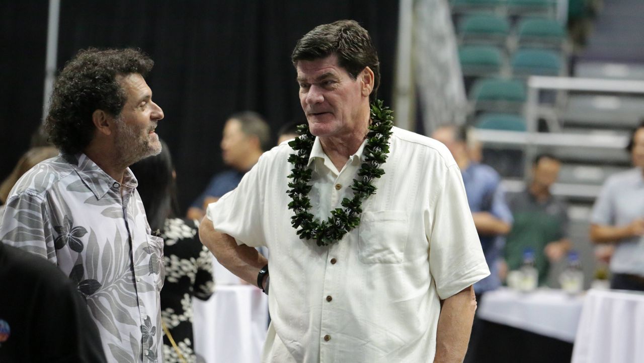 Outgoing Mountain West Conference Commissioner Craig Thompson, center, spoke to a fellow guest at the Hawaii Bowl Foundation's fundraiser at the Stan Sheriff Center on Tuesday.