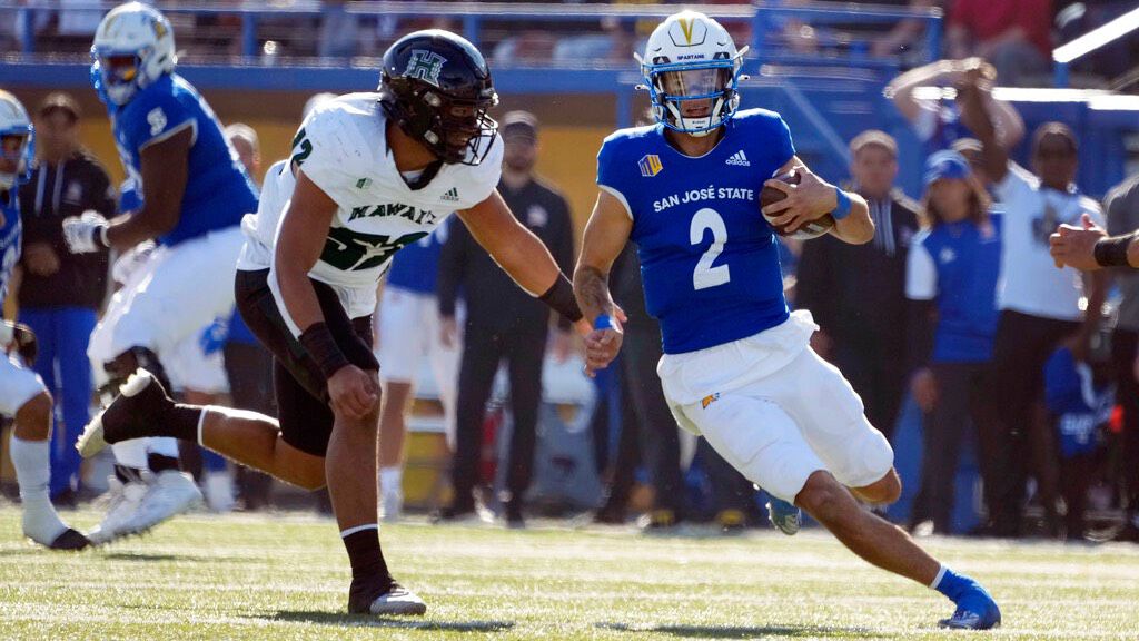 Former Hawaii quarterback Chevan Cordeiro ran the ball for San Jose State against UH's Ezra Evaimalo on Saturday at CEFCU Stadium in San Jose, Calif.