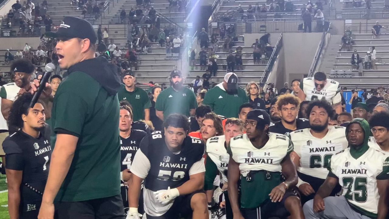 Hawaii football coach Timmy Chang spoke to the crowd after the spring game at Clarence T.C. Ching Athletics Complex as the Rainbow Warriors players took a knee.