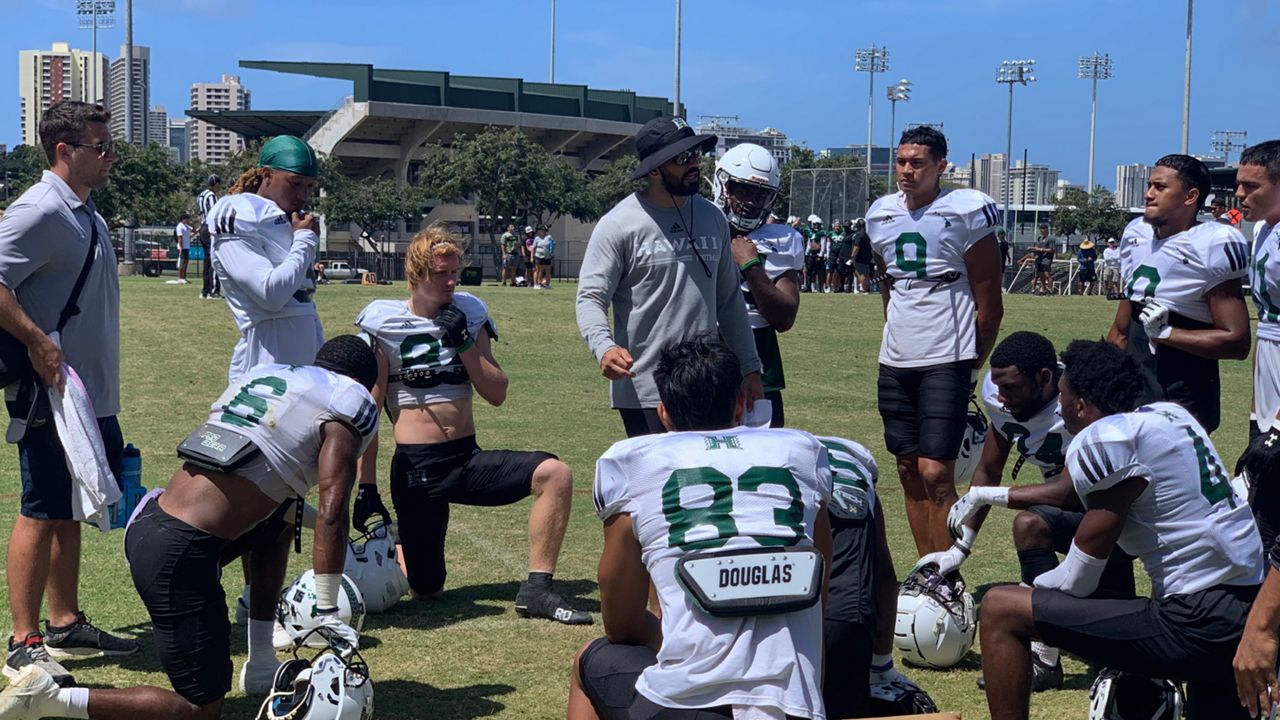 The Hawaii football team will execute two separate practices a day for two pods of players for roughly the first two weeks of camp, it was announced Tuesday. Seen here are the UH receivers and position coach Jared Ursua in the spring. (Spectrum News/Brian McInnis)