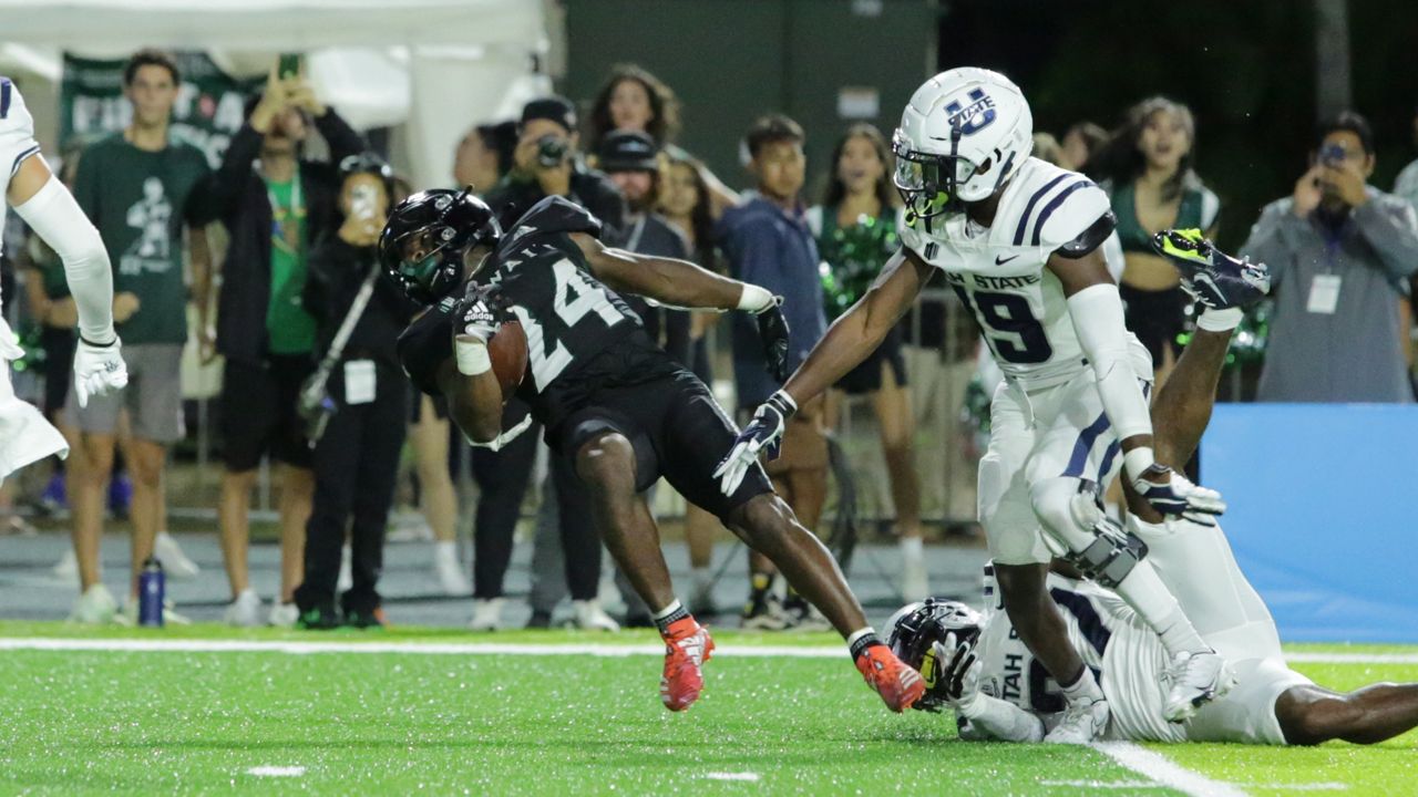 Hawaii running back Tylan Hines was tripped up by the Utah State defense and went down at the 1 yard line in the final minute.