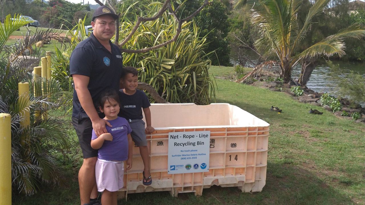 A new Net Bin at the Waikaea boat launch ramp in Kapaa. Harbor Master Mana Brown stands with his family at the installation of the Net Bin. (Courtesy Surfrider Foundation)
