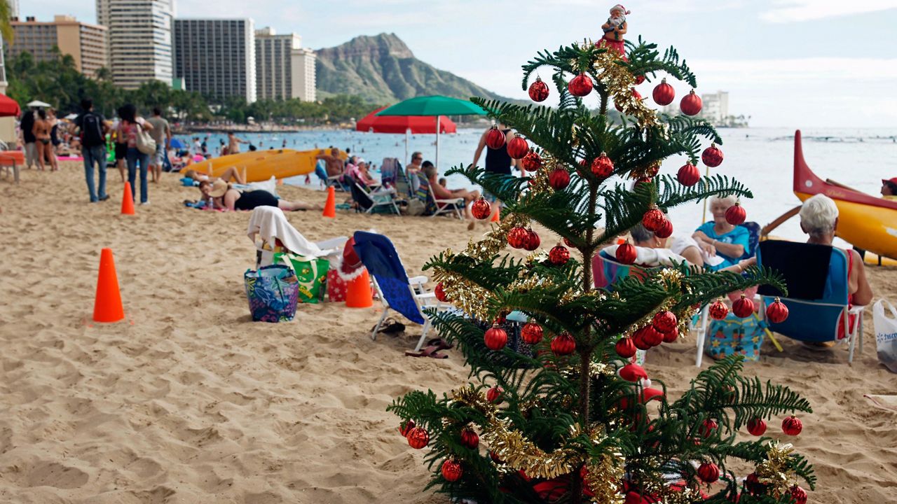 A Christmas tree is seen on Waikiki Beach. (AP Photo/Marco Garcia)