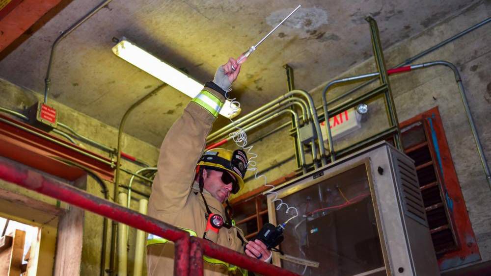 A firefighter with the Federal Fire Department Hawaii conducts environmental testing during the spill response exercise. (Photo Courtesy of U.S. Navy by Mass Communication Specialist 2nd Class Nick Bauer)