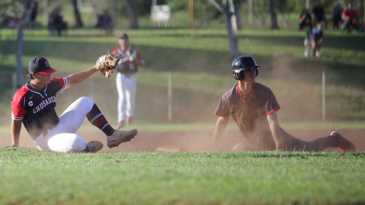 Saint Louis' Sean Yamaguchi and Iolani's Mana Lau Kong waited for a call at third base in an ILH baseball game on Thursday. Yamaguchi applied the tag but Lau Kong was ruled safe on his headfirst slide. The two players combined for five extra-base hits in the game.