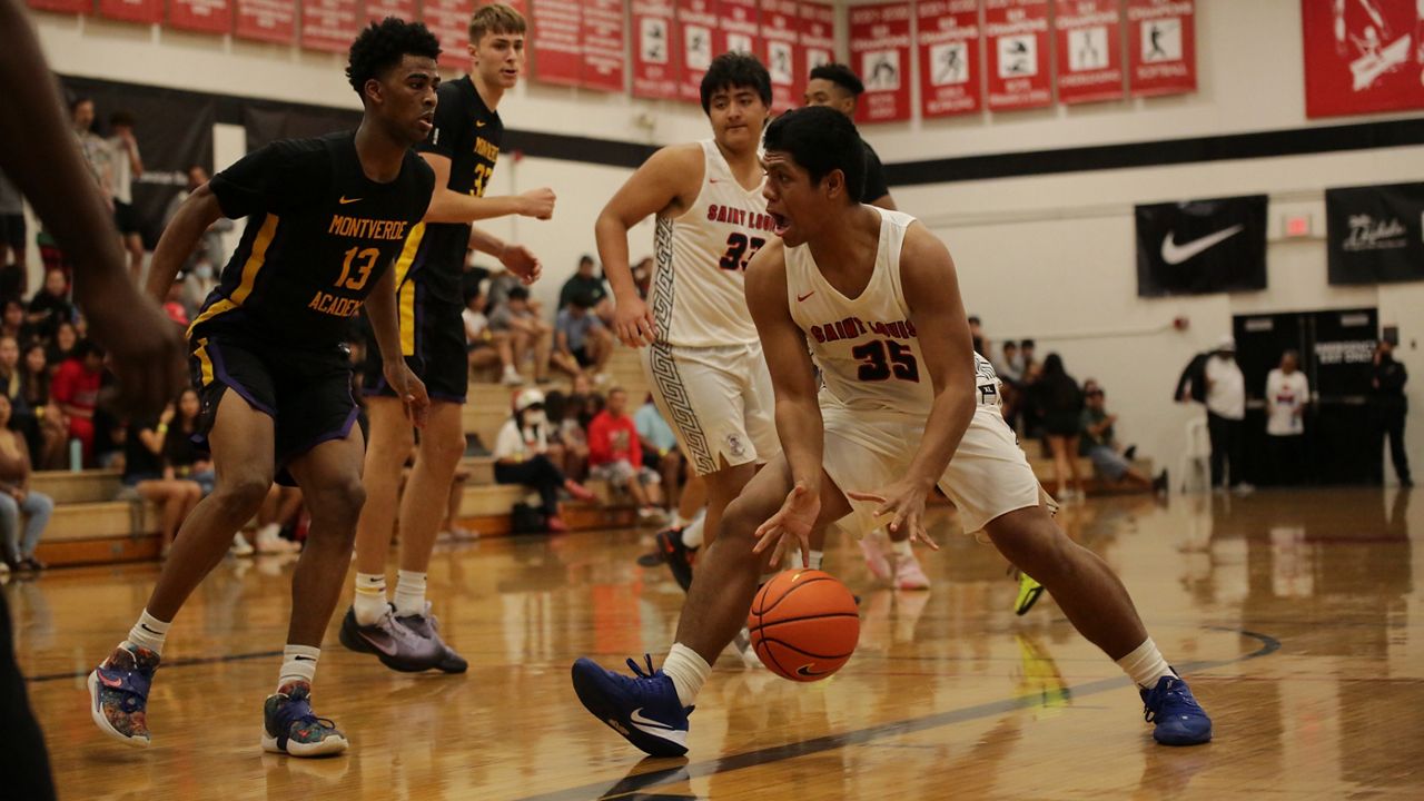 Saint Louis forward Pupu Sepulona drove against Montverde Academy's Sean Stewart on Friday night at Iolani's gym.