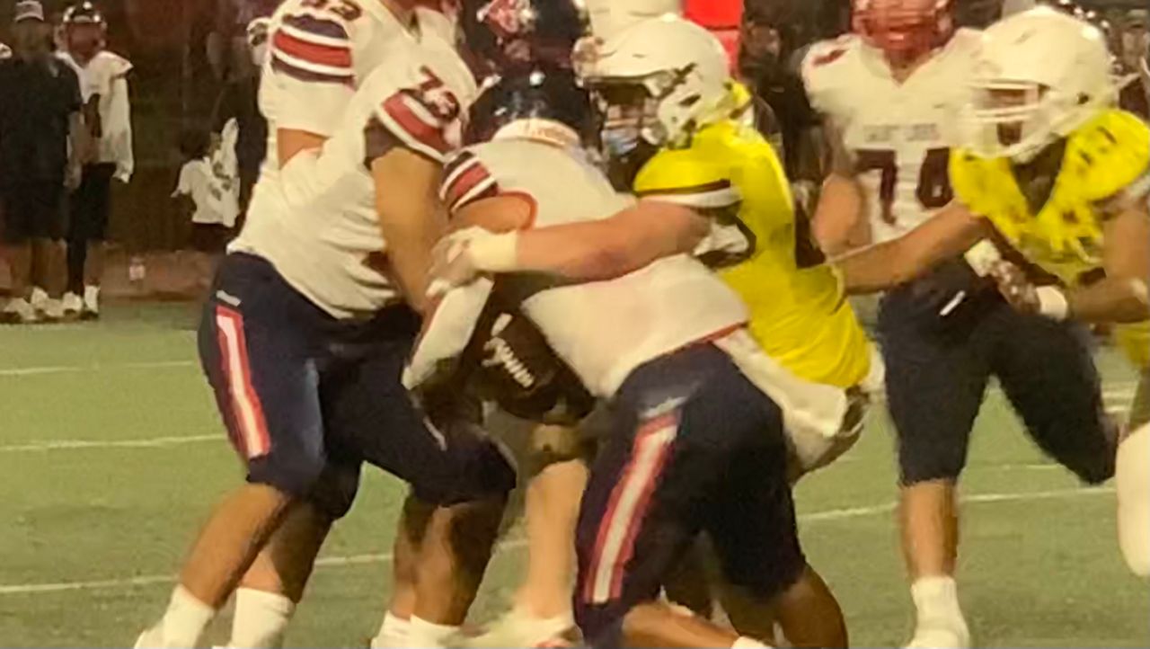 Mililani linebacker Elijah Nua brought down Saint Louis quarterback Ola Kamakawiwoole for a sack in the fourth quarter of the Trojans' season-opening 28-7 victory on Friday night.