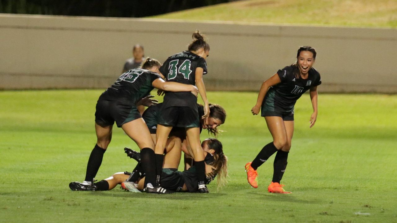 Amber Gilbert, right, and Kelci Sumida, bottom, connected on a second-half goal to put the Hawaii soccer team ahead of UC Davis on Thursday night. 