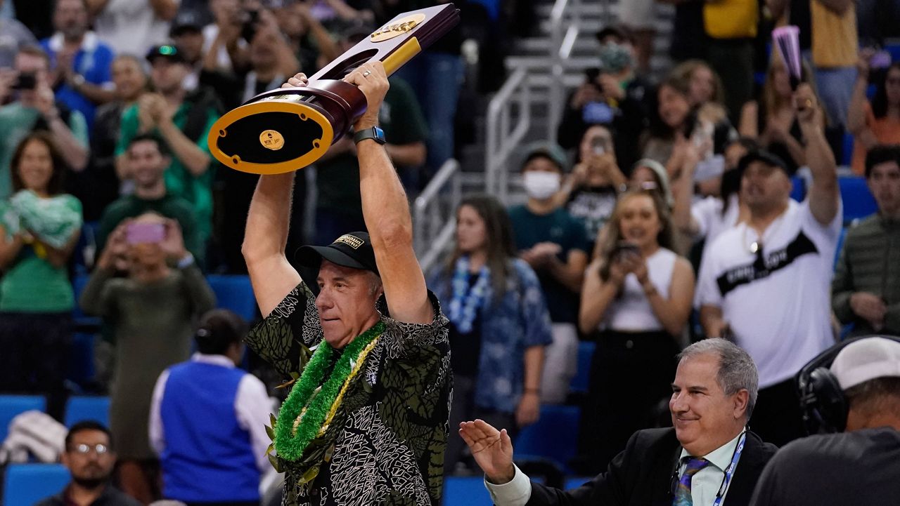 Hawaii coach Charlie Wade hoisted the NCAA men's volleyball championship trophy after the Rainbow Warriors defeated rival Long Beach State in the NCAA tournament final at UCLA on May 7.
