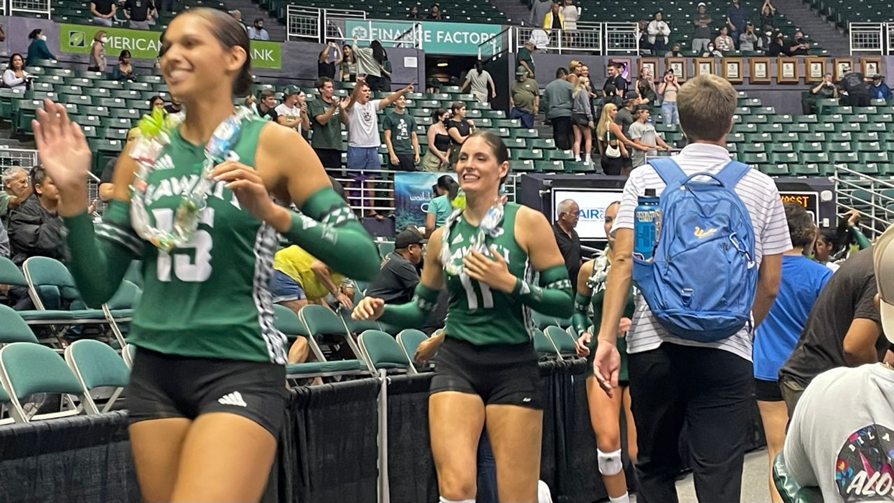 Mylana Byrd, left, and Tiffany Westerberg made the rounds of the Stan Sheriff Center floor after Hawaii defeated Texas State for the team's first win of the season.