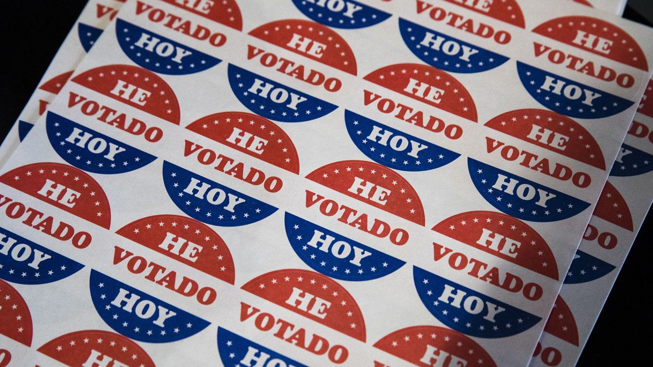 Spanish language voting stickers which read "He Votado Hoy" ("I Voted Today") are offered at a polling place in Philadelphia, May 21, 2019. (AP Photo/Matt Rourke, File)