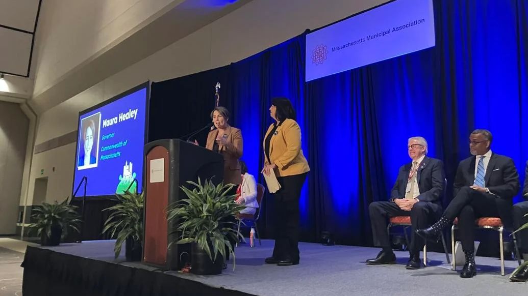 Gov. Maura Healey delivers remarks during the Massachusetts Municipal Association's annual meeting at the Hynes Convention Center on Friday, Jan. 19, 2024. She's joined on stage by Lt. Gov. Kim Driscoll. (State House News Service/Alison Kuznitz)