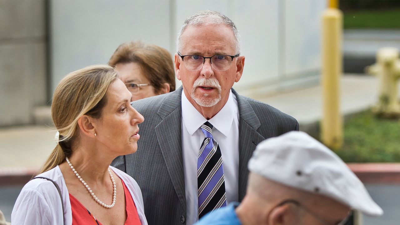 In this June 26, 2019, file photo, UCLA gynecologist James Heaps, center, arrives at Los Angeles Superior Court. (AP Photo/Damian Dovarganes)