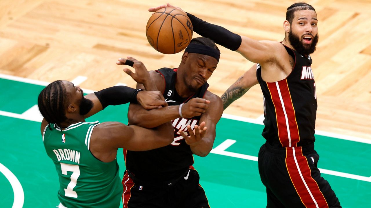 Celtics guard Jaylen Brown (left), Heat forward Jimmy Butler (center) and Miami forward Caleb Martin grapple for the ball during Game 7 of the NBA Eastern Conference Finals. (AP Photo/Michael Dwyer)