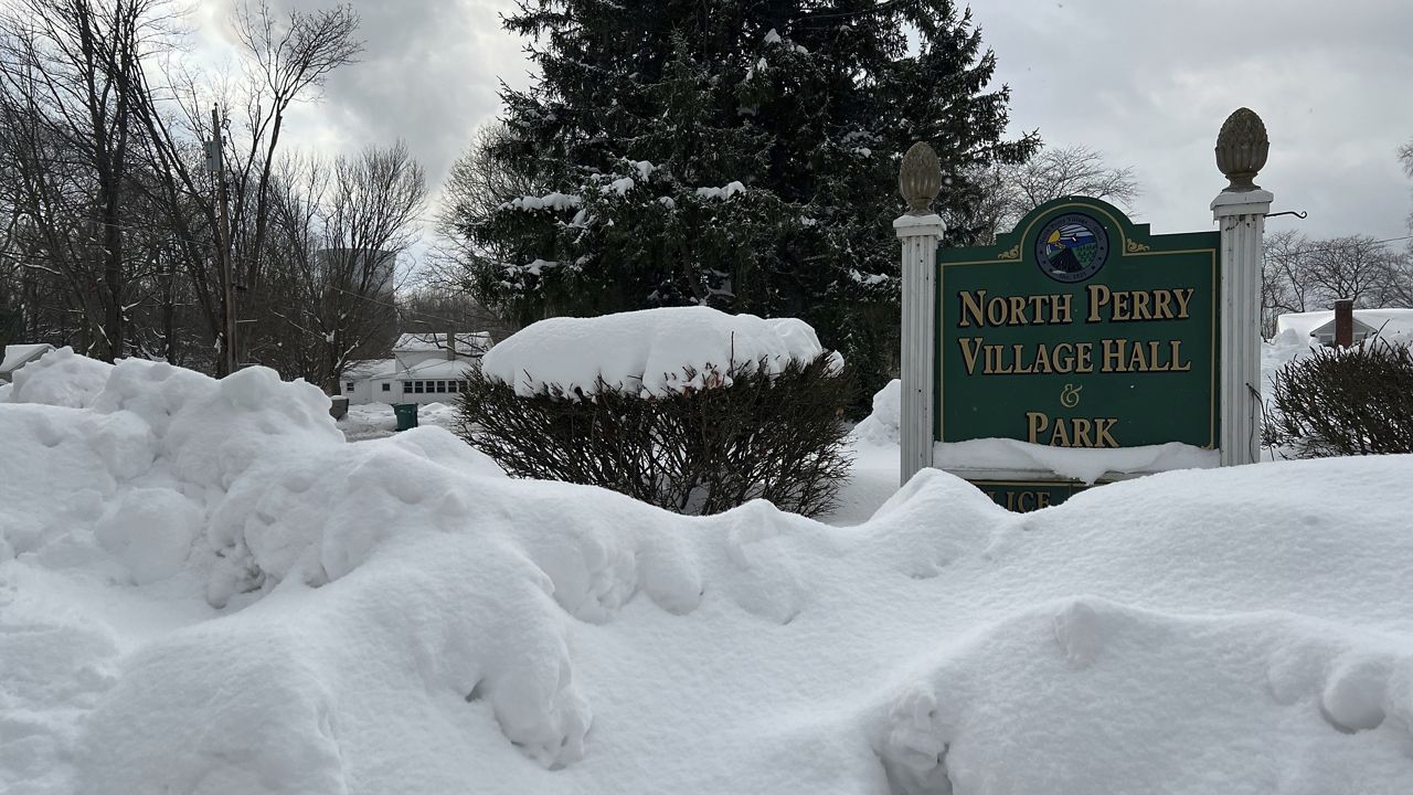 Snow covers the sign for the North Perry Village Hall in North Perry, Ohio on Tuesday, Dec. 3, 2024. (AP Photo/Patrick Aftoora-Orsagos)