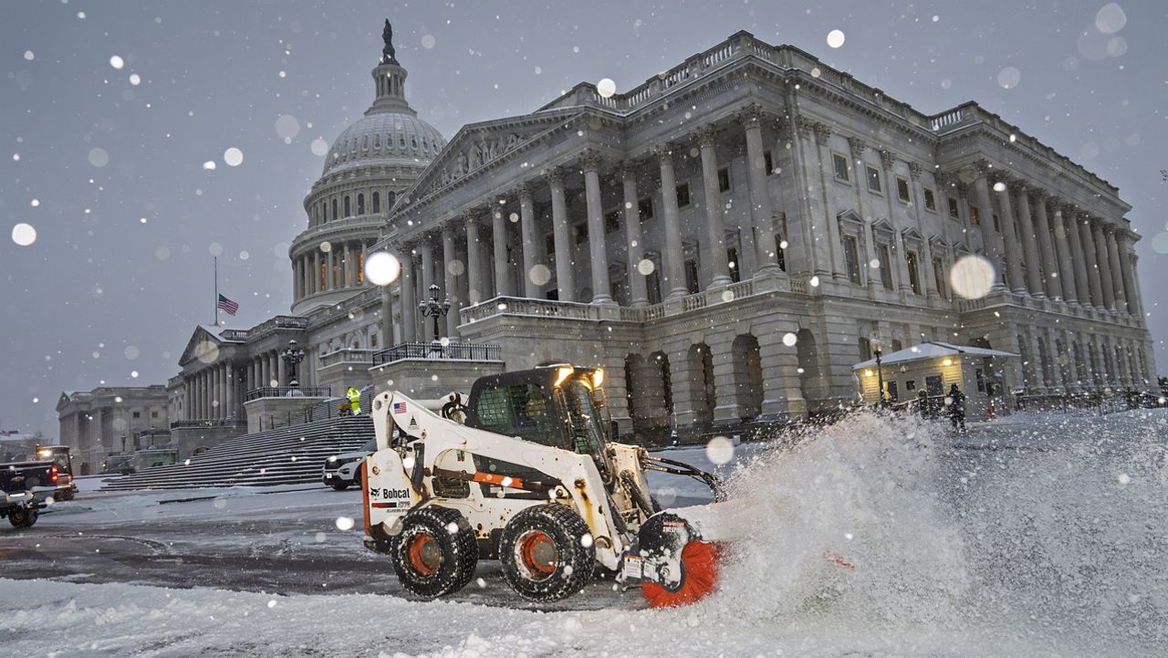 Workers clear the plaza at the Capitol as snow falls ahead of a joint session of Congress to certify the votes from the Electoral College in the presidential election, in Washington, Monday, Jan. 6, 2025. (AP Photo/J. Scott Applewhite)