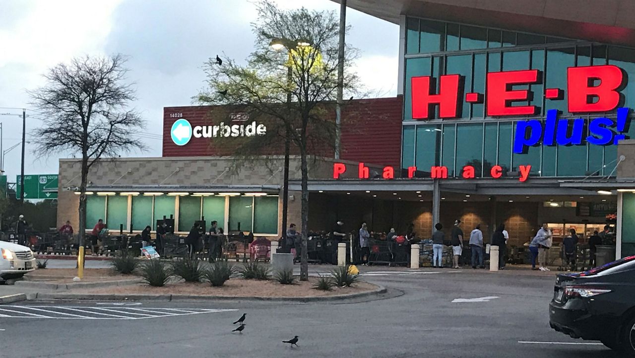 An image of an H-E-B Plus in Austin as a line forms outside (Spectrum News/File)