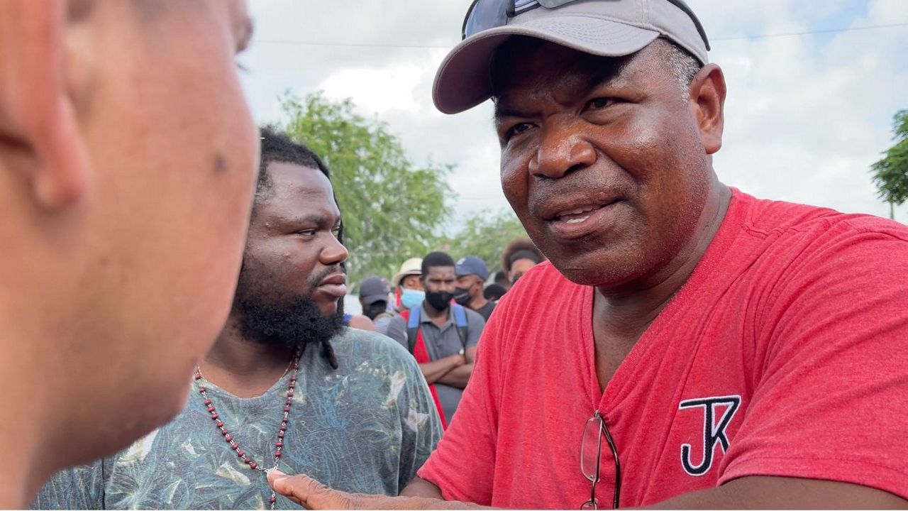 Pasto Hector Silva talks to Haitians looking for refuge