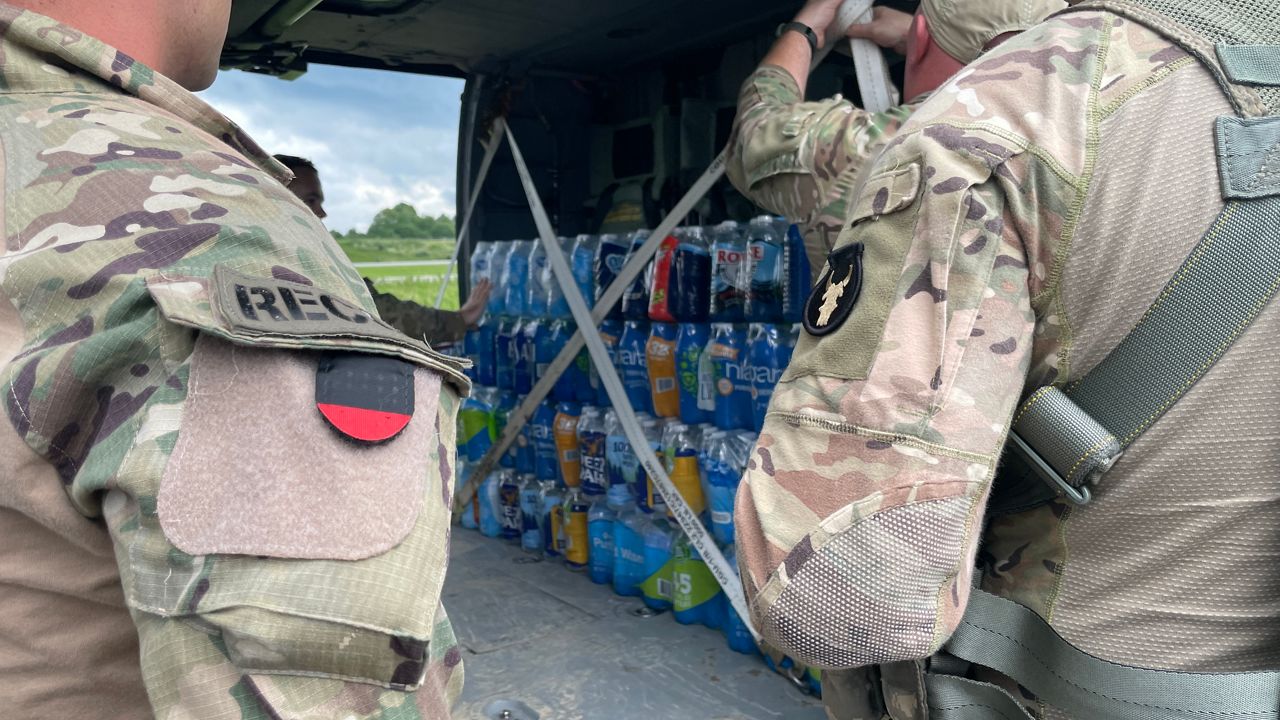 National Guardsmen load water onto a Blackhawk helicopter near Hazard (Spectrum News 1/Mason Brighton)