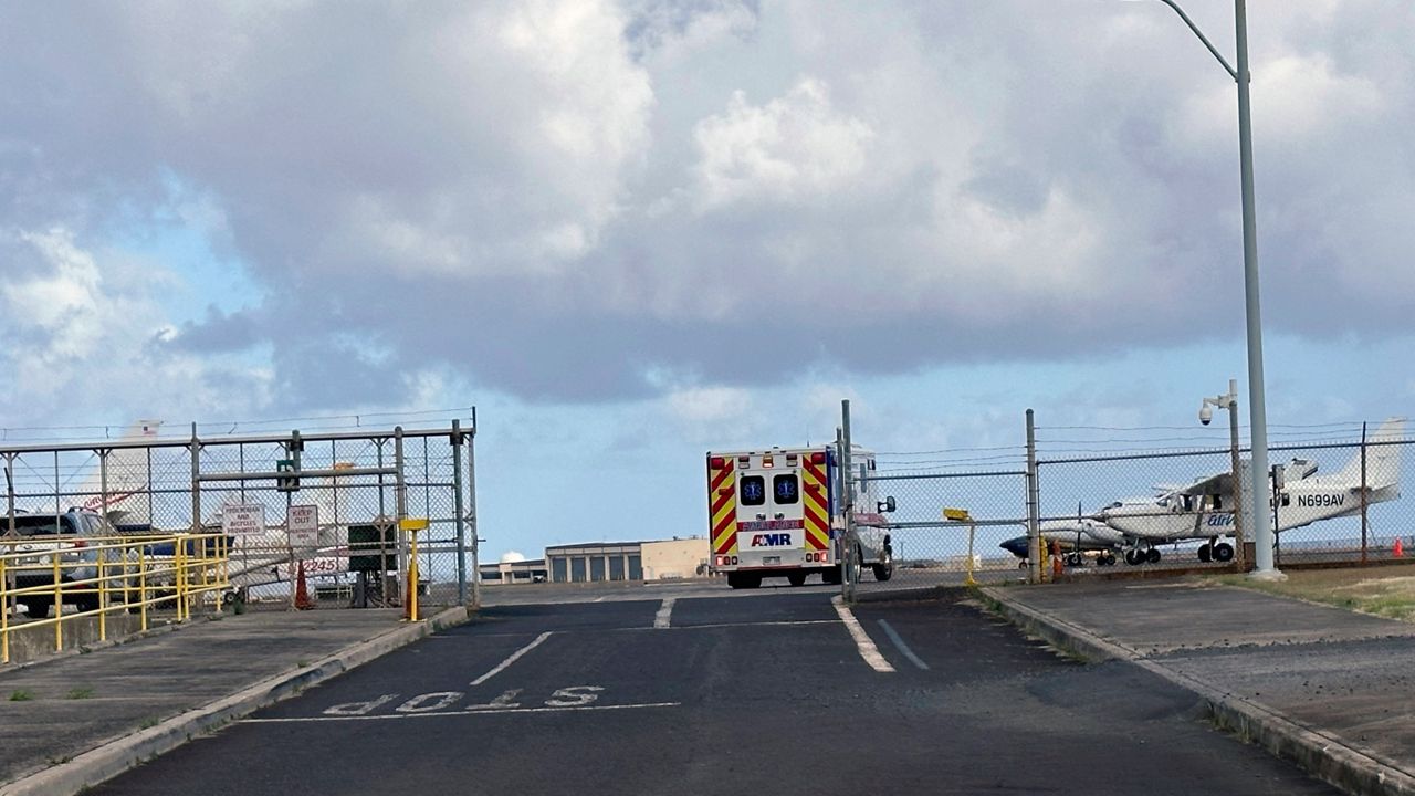 An ambulance enters Lihue Airport on the island of Kauai, Hawaii on Friday, July 12, 2024. A helicopter crashed into the ocean off the Hawaiian island of Kauai on Thursday leaving one person dead and two others missing, the Kauai Police Department said. (Chris Jensen via AP)