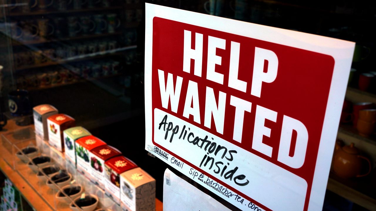 A help-wanted sign hangs in the front window of the Bar Harbor Tea Room in Bar Harbor, Maine, on June 11. (AP Photo/Robert F. Bukaty, File)
