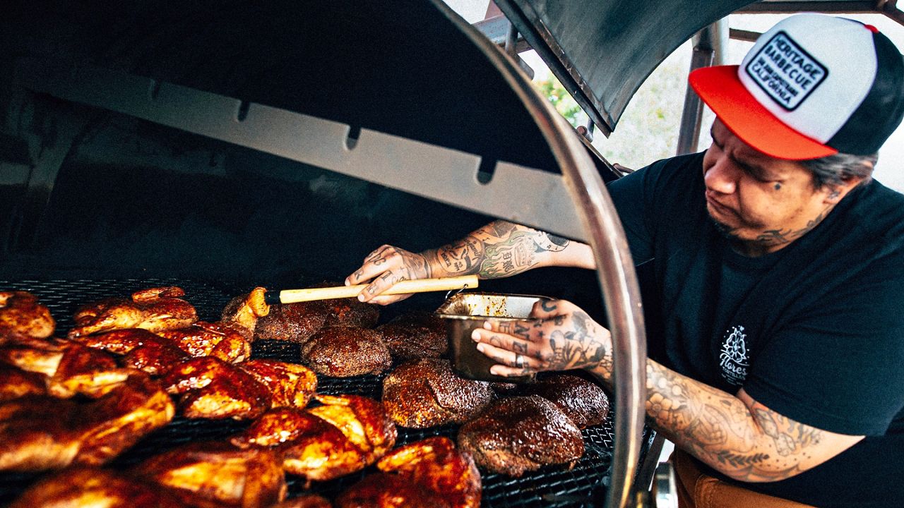 Heritage Barbecue owner and pitmaster Daniel Castillo marinates meat in one of their offset smokers in San Juan Capistrano (Courtesy Heritage Barbecue)