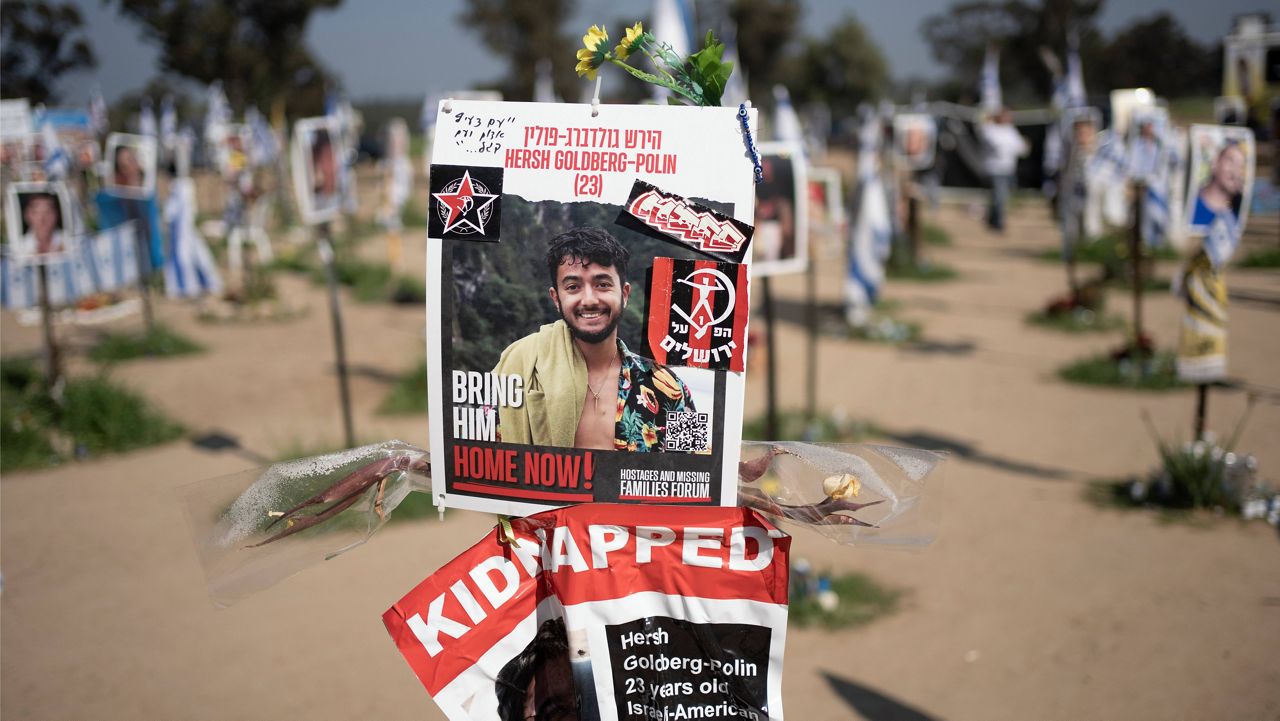 A poster depicting Israeli-American hostage Hersh Goldberg-Polin is displayed in Re'im, southern Israel at the Gaza border, Feb. 26, 2024, at a memorial site for the Nova music festival site where he was kidnapped to Gaza by Hamas on Oct. 7, 2023. (AP Photo/Maya Alleruzzo, File) 
