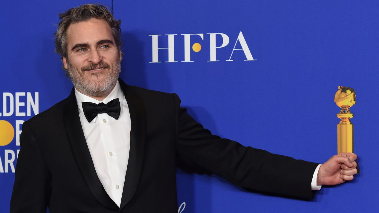 Joaquin Phoenix pretends to hold his award for best performance by an actor in a motion picture drama for "Joker" in the press room at the 77th annual Golden Globe Awards at the Beverly Hilton Hotel on Sunday, Jan. 5, 2020, in Beverly Hills, Calif. (AP Photo/Chris Pizzello)