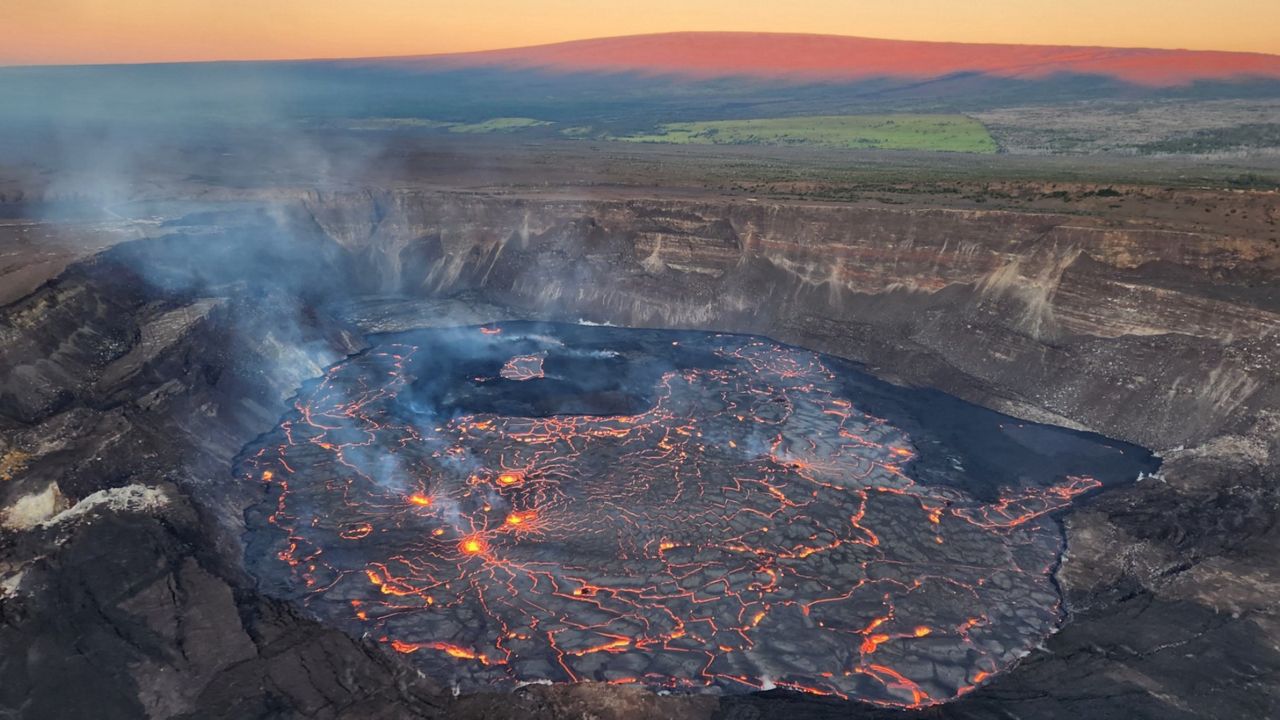 This view from a sunrise overflight at 6:45 a.m. HST shows the Kilauea eruption is confined to Halemaʻumaʻu crater in the summit caldera. Mauna Loa (not erupting) is along the horizon in the background. (Photo courtesy of USGS)