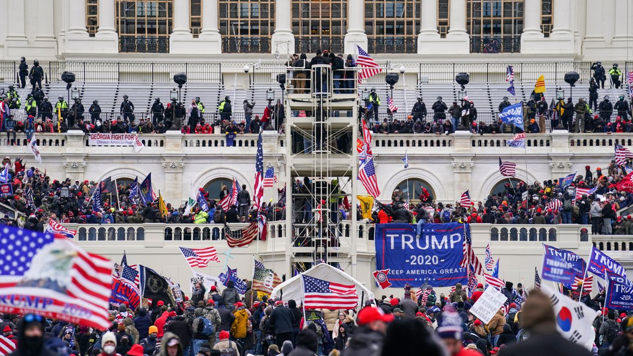 Insurrectionists loyal to President Donald Trump breach the Capitol in Washington, Jan. 6, 2021. The founder of the Hawaii Proud Boys chapter and another man who stormed the Capitol on Jan. 6, 2021, and posed for a picture in front of a door one of them inked with the words “Murder the Media” have admitted to a felony charge in the riot. Nicholas Ochs, the founder of the group’s Hawaii chapter, and Nicholas DeCarlo, of Fort Worth, Texas pleaded guilty on Friday, Sept. 9, 2022, to obstructing the certification of President Joe Biden’s Electoral College victory. (AP Photo/John Minchillo, File)